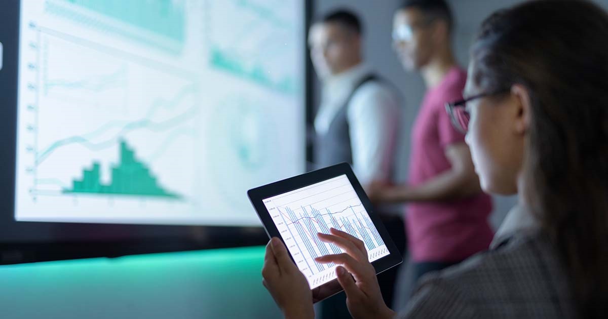 Businessperson viewing graphs on a tablet Businessperson viewing graphs on a tablet