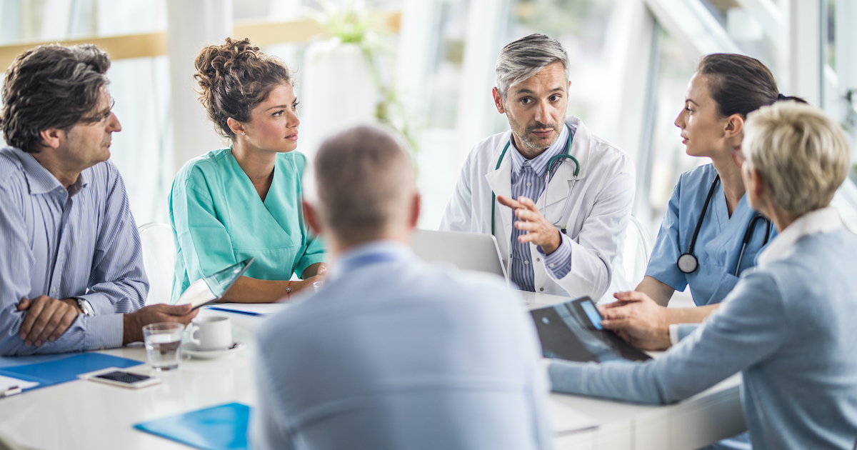 Doctors, nurses and healthcare executives meeting around a table Doctors, nurses and healthcare executives meeting around a table