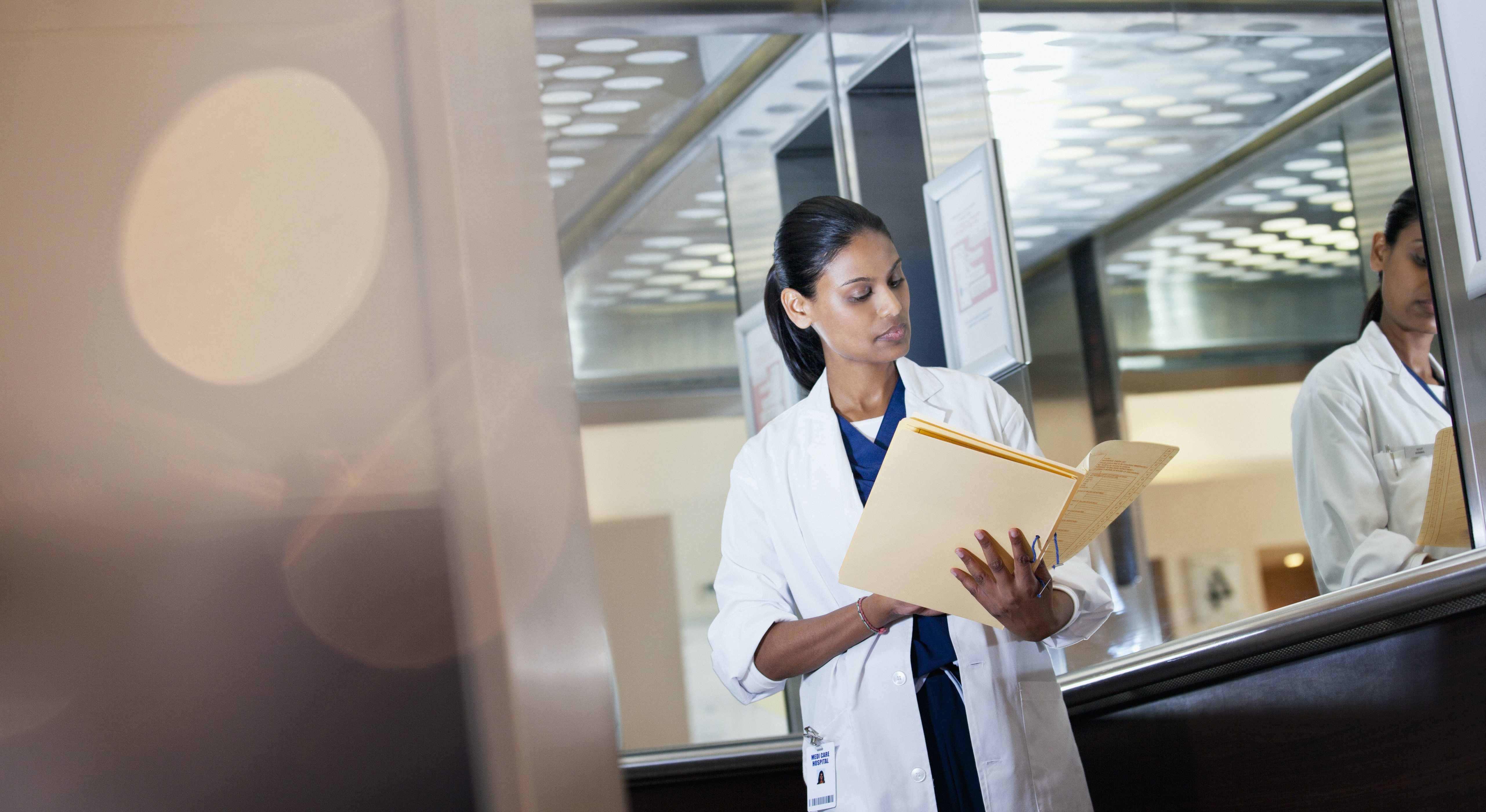 A doctor reviewing a paper patient record
