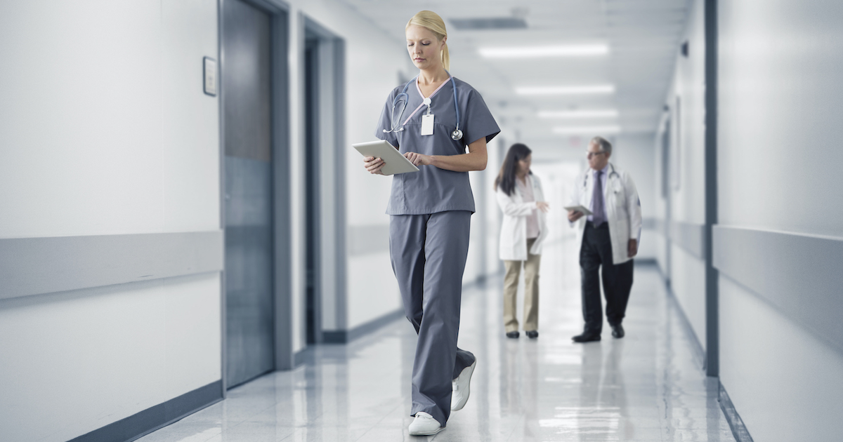 A doctor checking a patient's record on their digital tablet A doctor checking a patient's record on their digital tablet