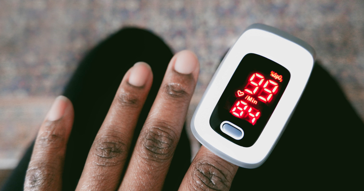 Left hand wearing a pulse oximeter Left hand wearing a pulse oximeter