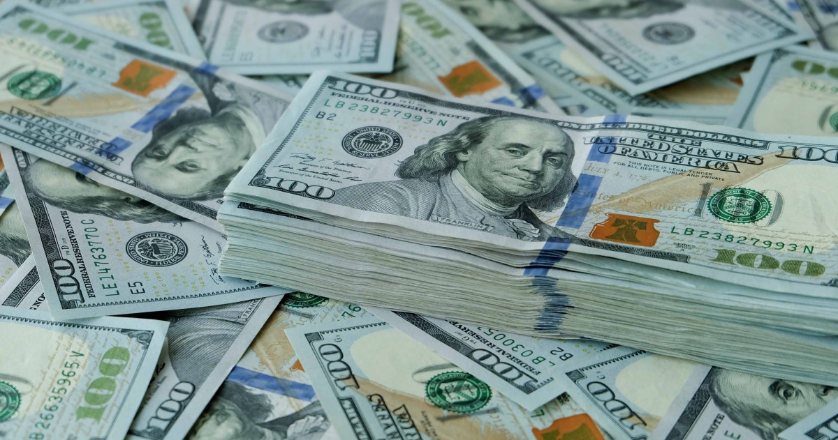 Stack of $100 U.S. dollars on loose bills Stack of $100 U.S. dollars on loose bills