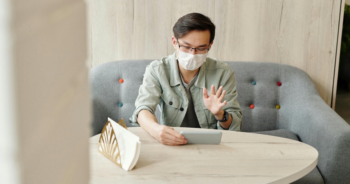 A patient wearing mask at home in an online consultation. A patient wearing mask at home in an online consultation.