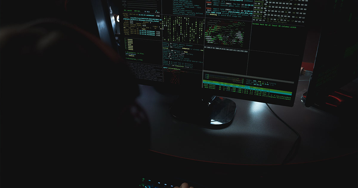 monitor on dark desktop shows multiple screens of data monitor on dark desktop shows multiple screens of data