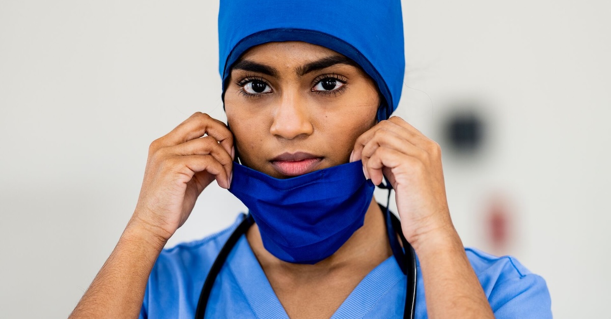 Healthcare worker taking off mask