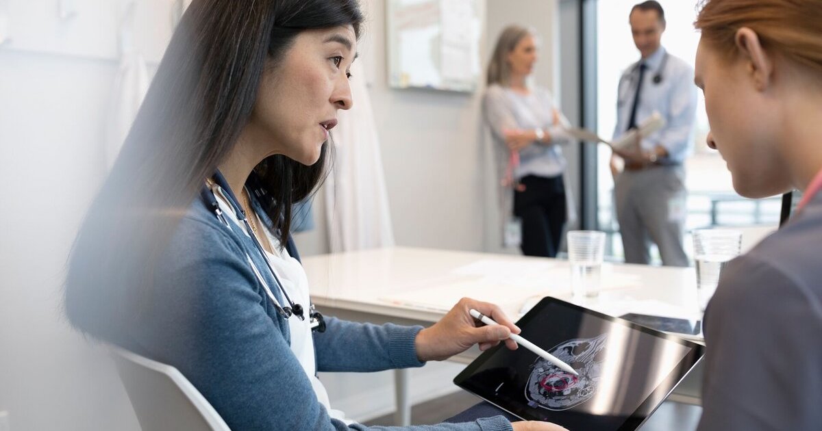 Doctors reviewing a patient's brain scan
