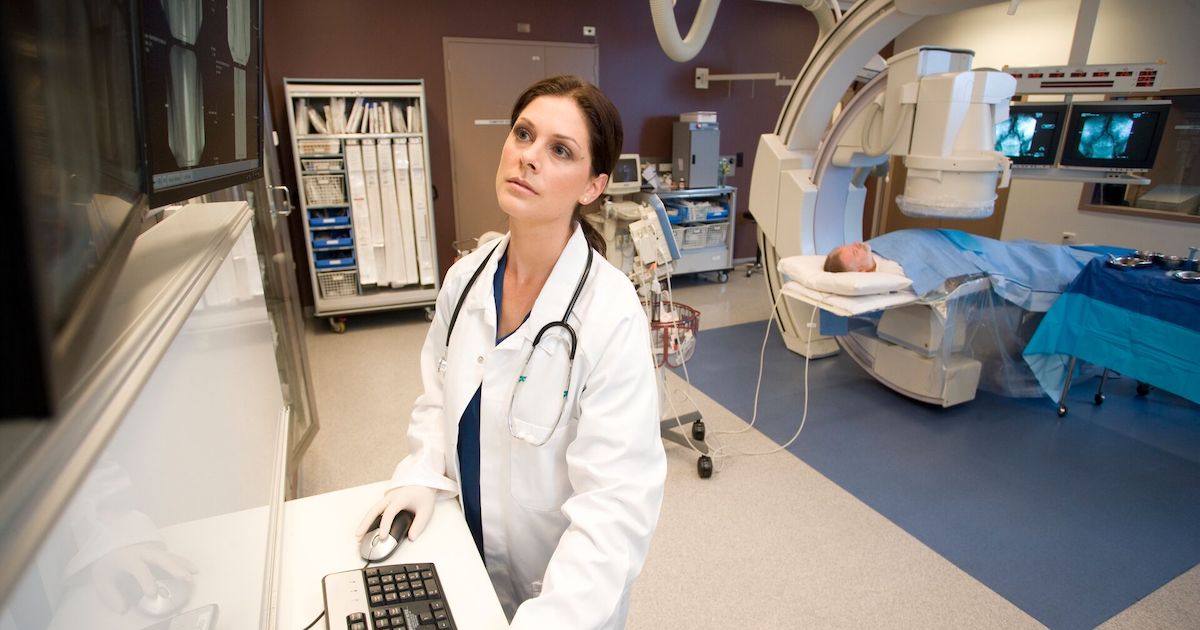 A doctor inspecting a patient's X-ray image on a monitor
