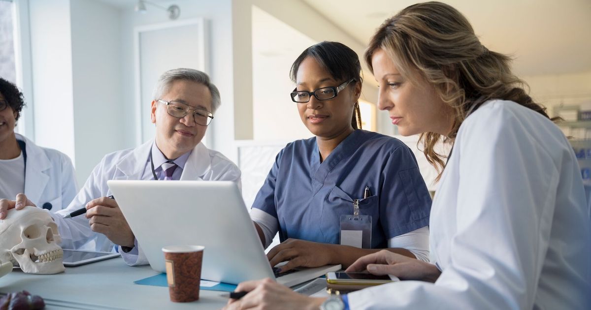 Doctors review information on a laptop Doctors review information on a laptop