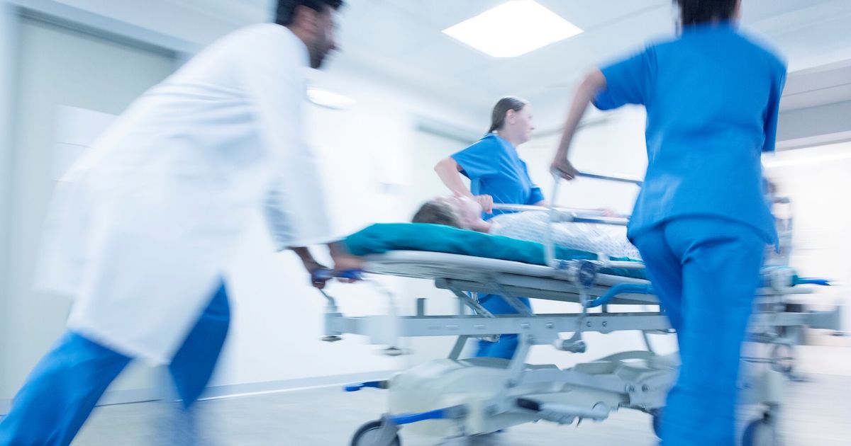 An emergency team pushing a patient on a gurney