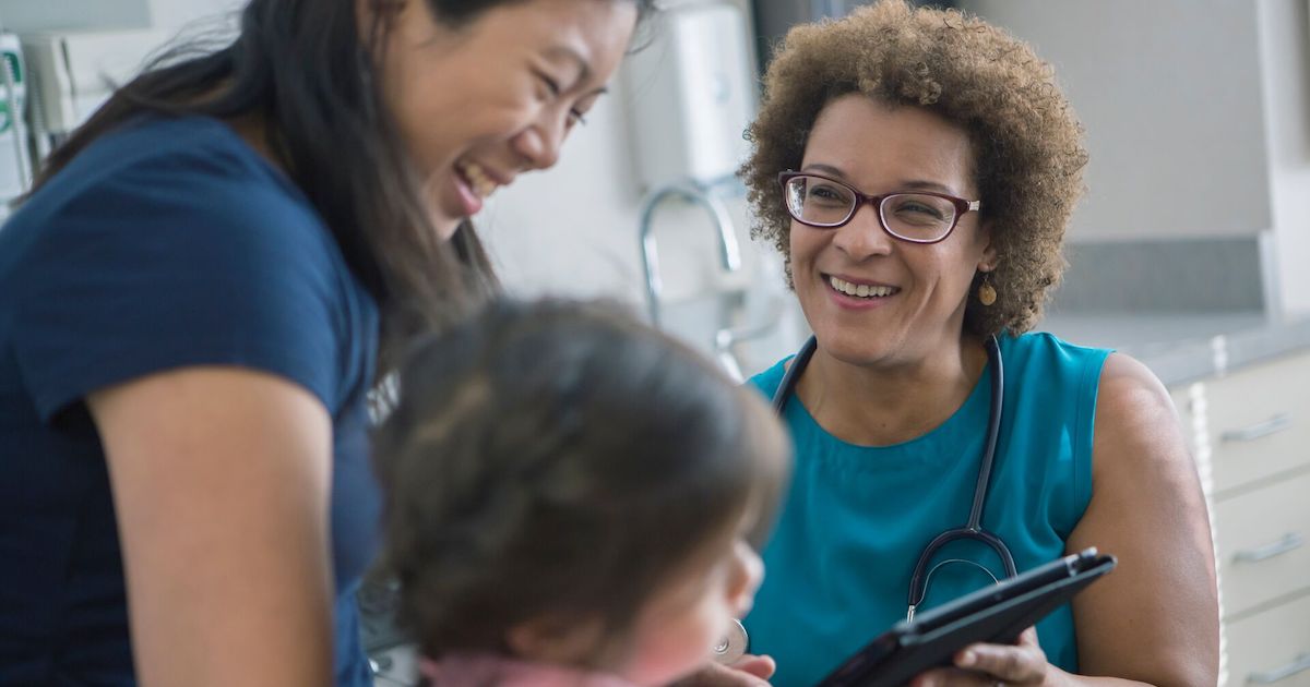 Doctor speaks with mother and child Doctor speaks with mother and child