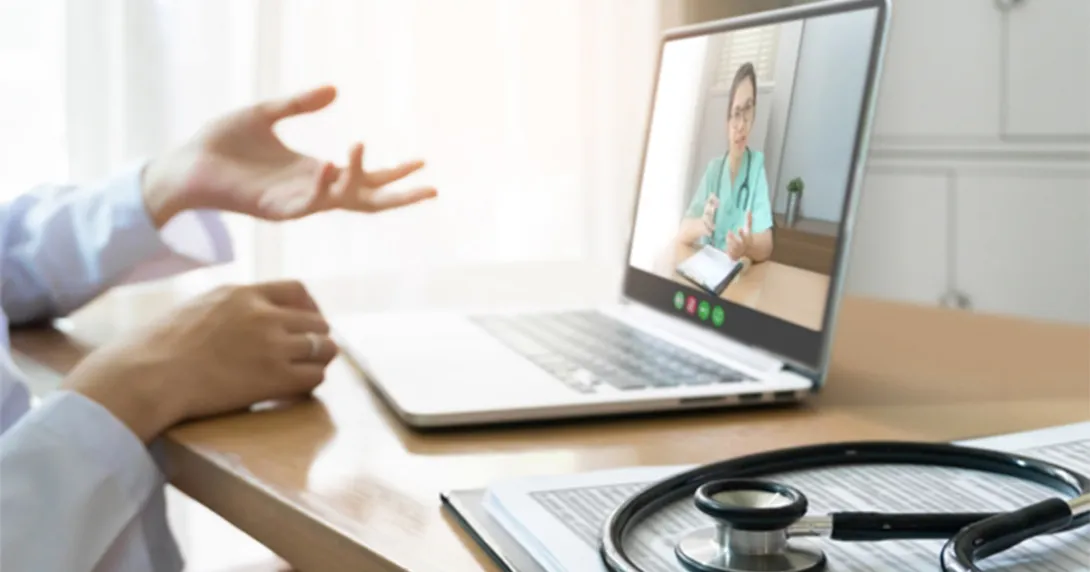 clinician hands and laptop open to a telehealth call clinician hands and laptop open to a telehealth call
