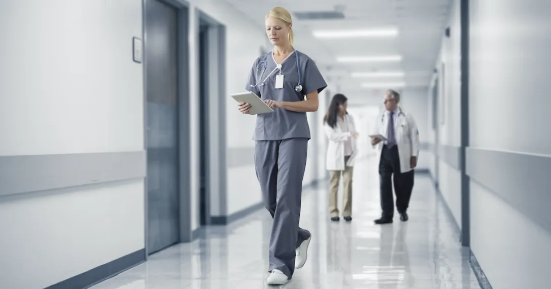 A doctor checking a patient's record on their digital tablet A doctor checking a patient's record on their digital tablet