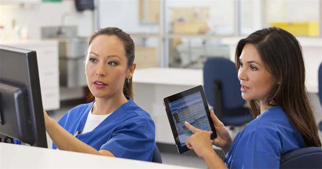 Nurses talking and pointing at device screens Nurses talking and pointing at device screens