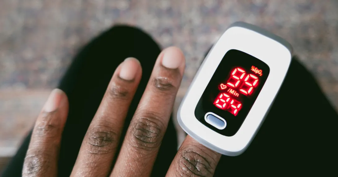 Left hand wearing a pulse oximeter Left hand wearing a pulse oximeter