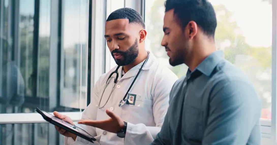 Doctor showing tablet to patient Doctor showing tablet to patient