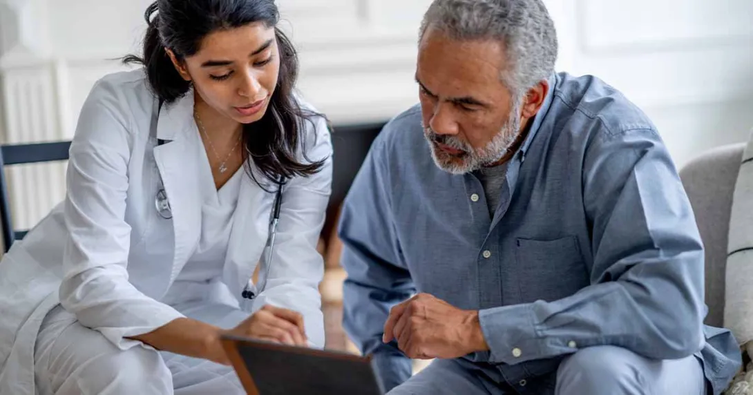 Doctor showing tablet to patient Doctor showing tablet to patient