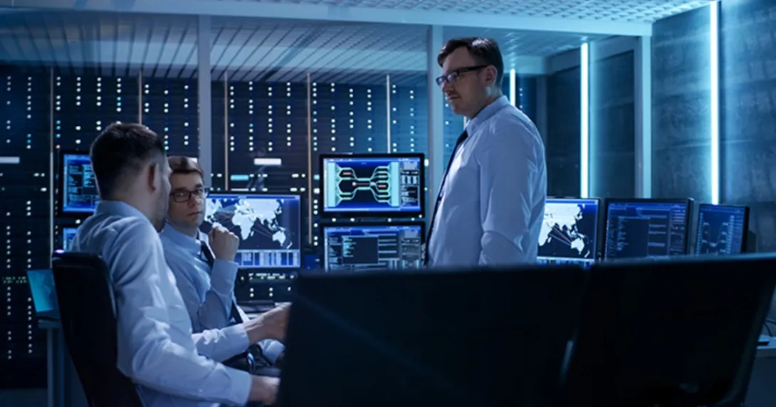 IT professionals meet in a server room IT professionals meet in a server room