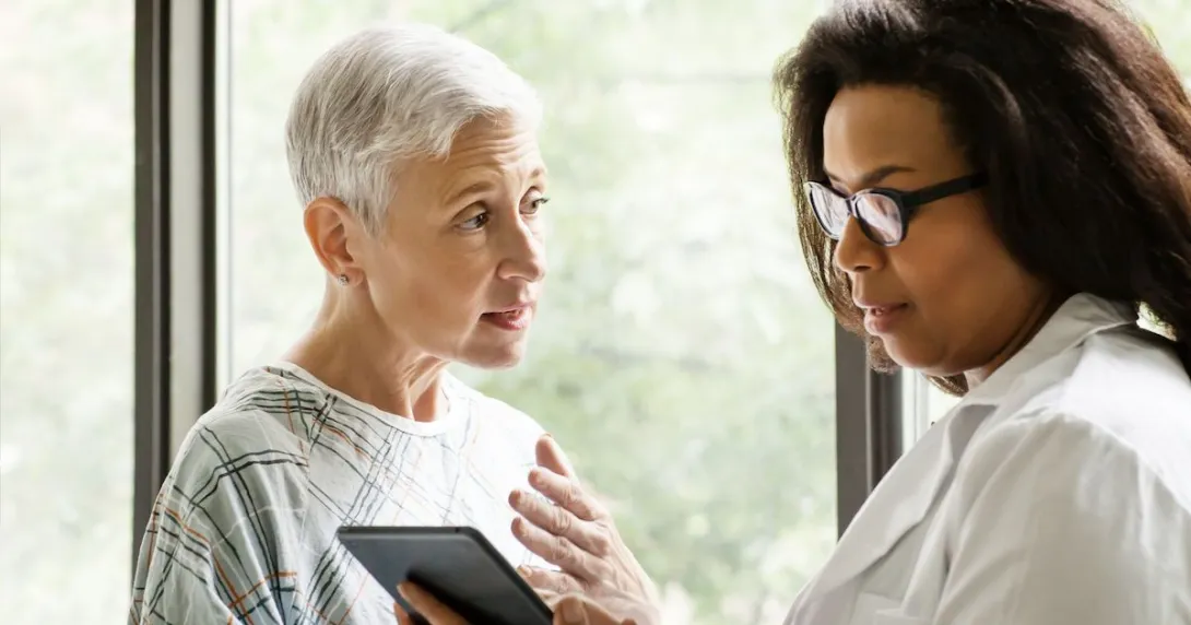 A doctor explaining a senior patient's test results using a digital tablet A doctor explaining a senior patient's test results using a digital tablet